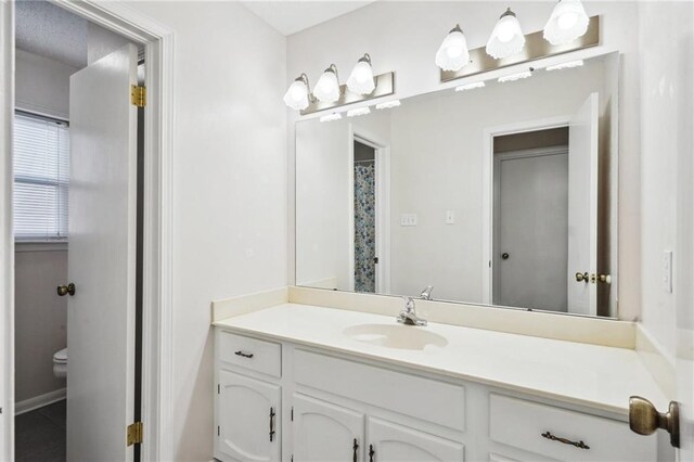 bathroom featuring vanity and toilet