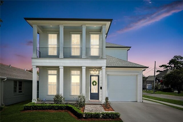 view of front of property with a balcony, a garage, a lawn, and a porch