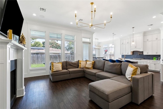 living room featuring dark wood-type flooring and ornamental molding