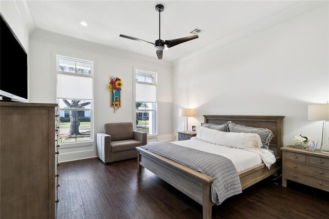 bedroom featuring ornamental molding, ceiling fan, and dark hardwood / wood-style flooring