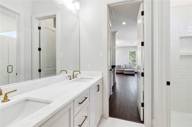 bathroom with vanity, hardwood / wood-style flooring, and a shower with shower door