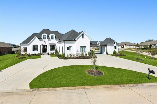 french provincial home featuring a garage and a front yard