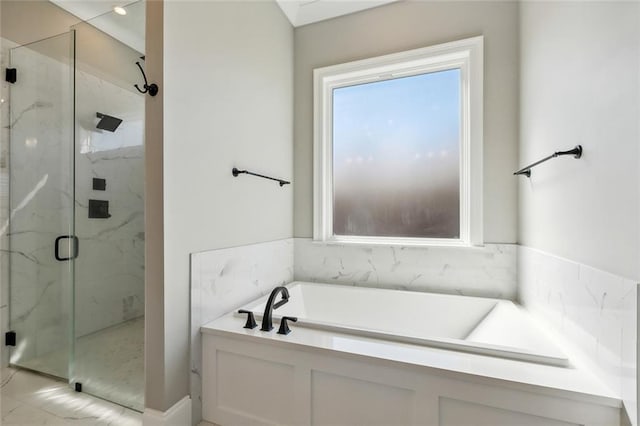 bathroom featuring a healthy amount of sunlight and separate shower and tub