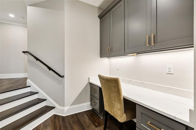 office area featuring dark hardwood / wood-style flooring and built in desk