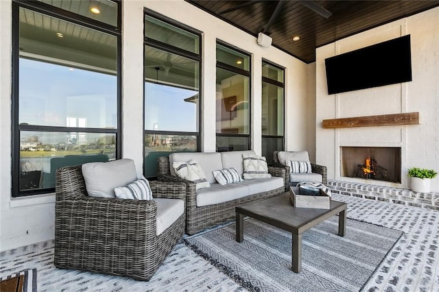 view of patio / terrace with an outdoor living space with a fireplace