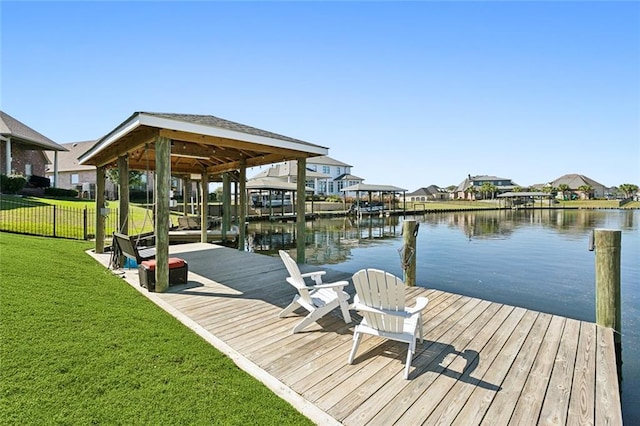 dock area featuring a water view and a yard