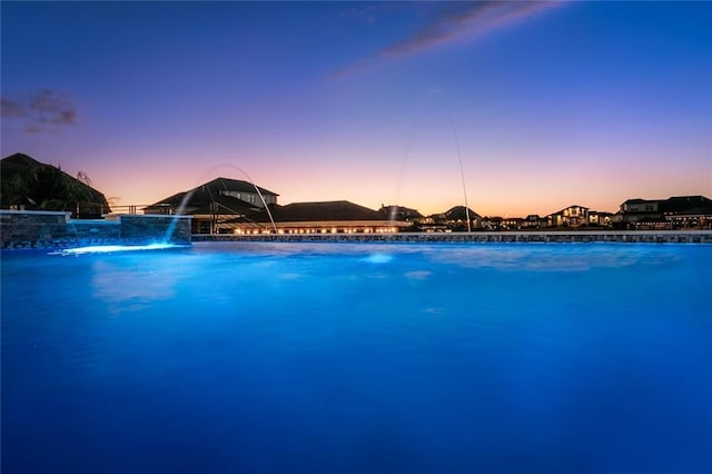 view of pool at dusk