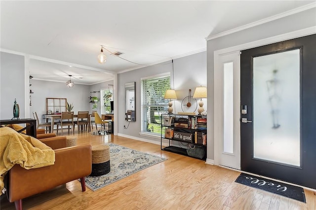 living room featuring light hardwood / wood-style flooring and ornamental molding