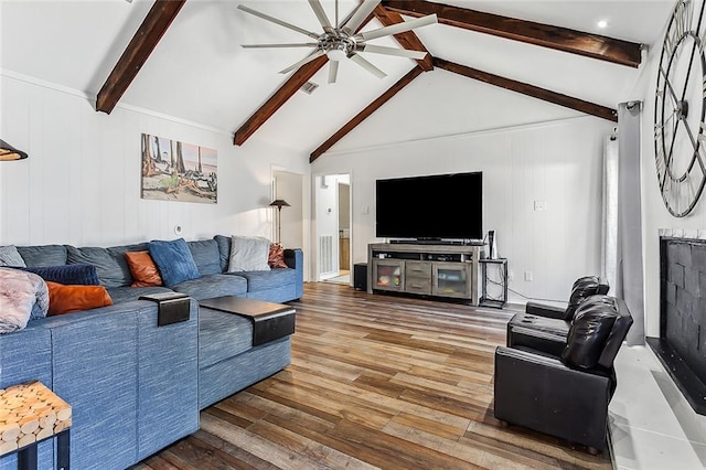 living room with hardwood / wood-style flooring, lofted ceiling with beams, and ceiling fan