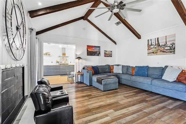 living room with beam ceiling, hardwood / wood-style flooring, high vaulted ceiling, and ceiling fan