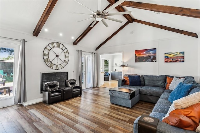 living room with high vaulted ceiling, hardwood / wood-style flooring, beamed ceiling, and ceiling fan