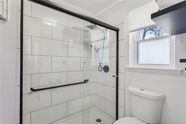 bathroom featuring toilet, crown molding, and walk in shower