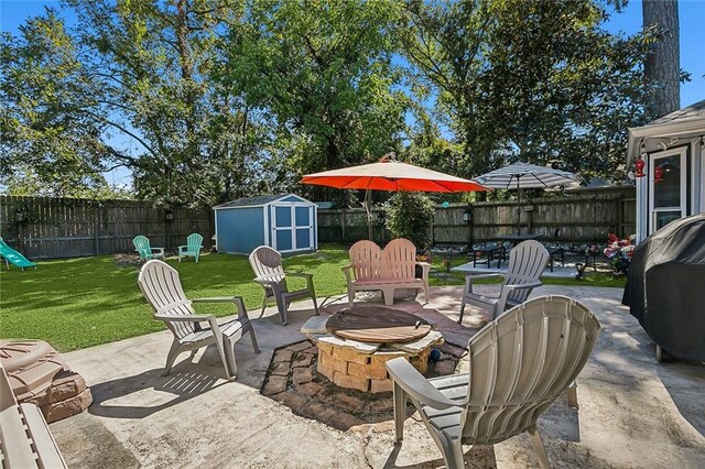 view of patio / terrace with an outdoor fire pit and a shed