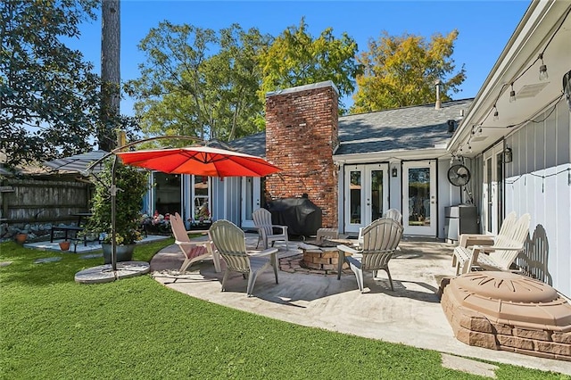 exterior space featuring french doors, an outdoor fire pit, and area for grilling