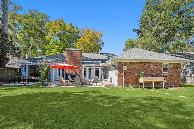 rear view of house with a patio area and a yard