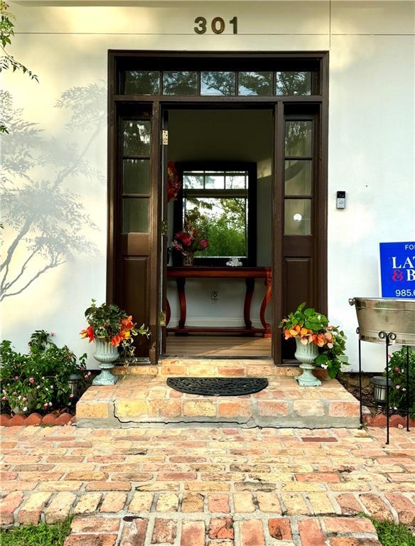 doorway to property featuring stucco siding