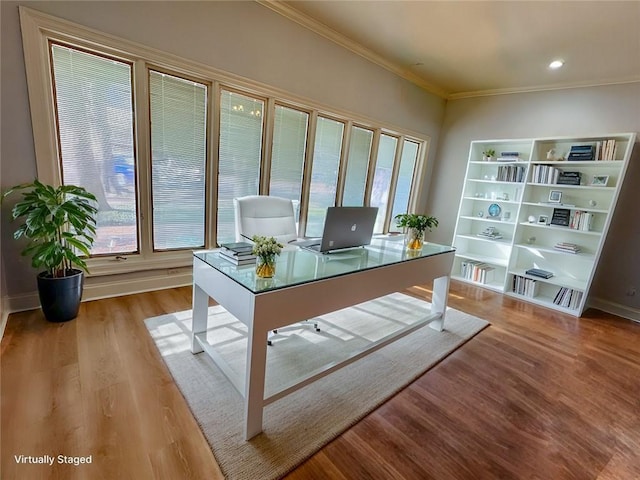 office space with light wood-type flooring, baseboards, ornamental molding, and recessed lighting