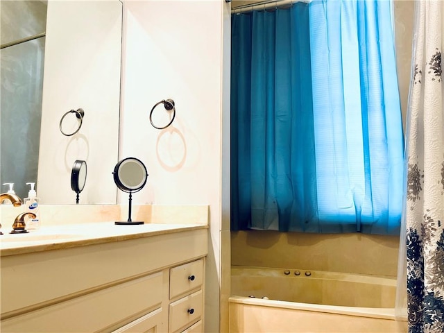 bathroom featuring shower / bathtub combination with curtain and vanity