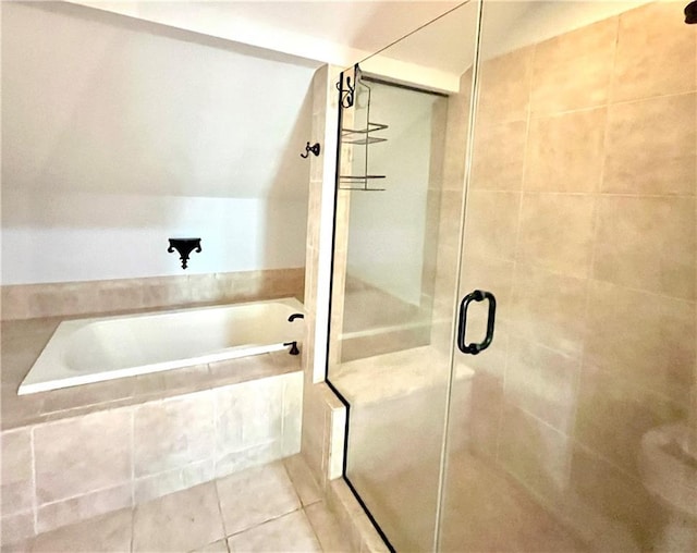 bathroom with a garden tub, a shower stall, and tile patterned floors