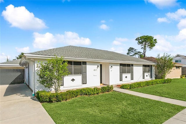 single story home with a front lawn and a garage