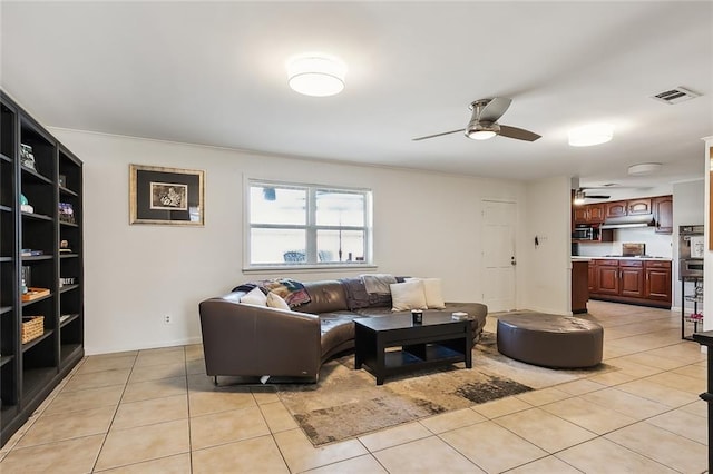 living room featuring ceiling fan and light tile patterned floors