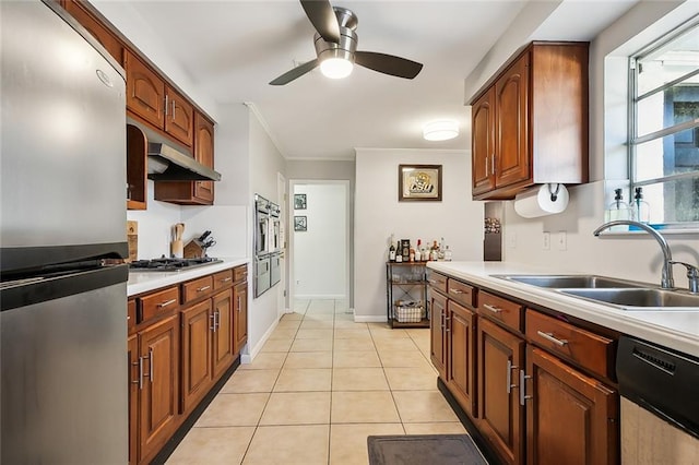 kitchen with ceiling fan, light tile patterned floors, ornamental molding, sink, and stainless steel appliances