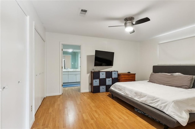 bedroom featuring hardwood / wood-style floors, ensuite bath, and ceiling fan