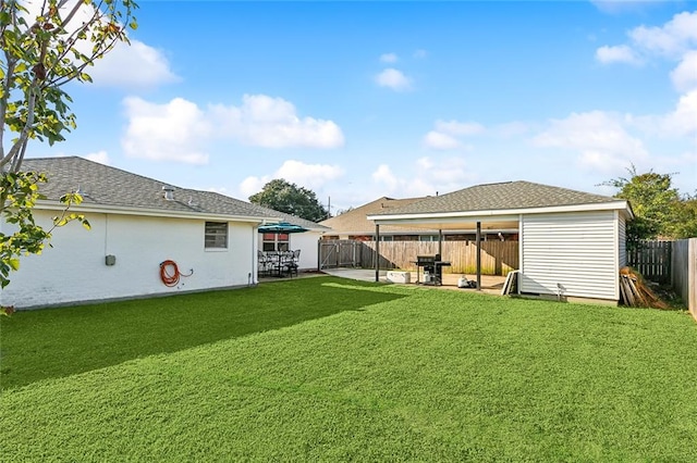 rear view of property featuring a patio area and a lawn