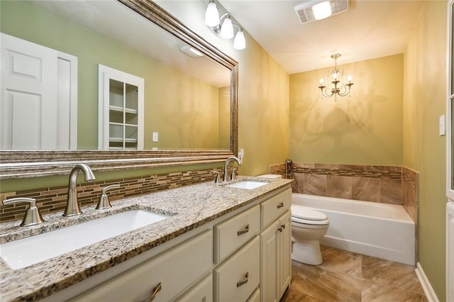 bathroom with vanity, an inviting chandelier, toilet, tasteful backsplash, and a tub