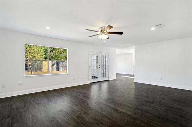 empty room with dark hardwood / wood-style floors, ceiling fan, and french doors