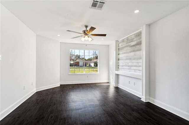 empty room featuring dark hardwood / wood-style floors and ceiling fan