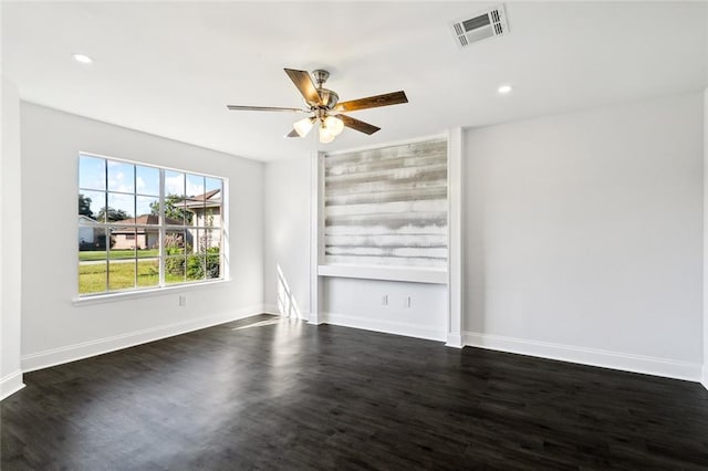 spare room featuring dark hardwood / wood-style floors and ceiling fan