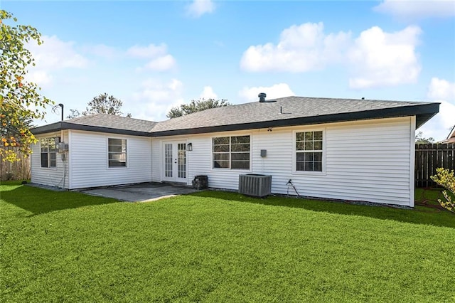 back of property with central AC unit, a yard, a patio, and french doors