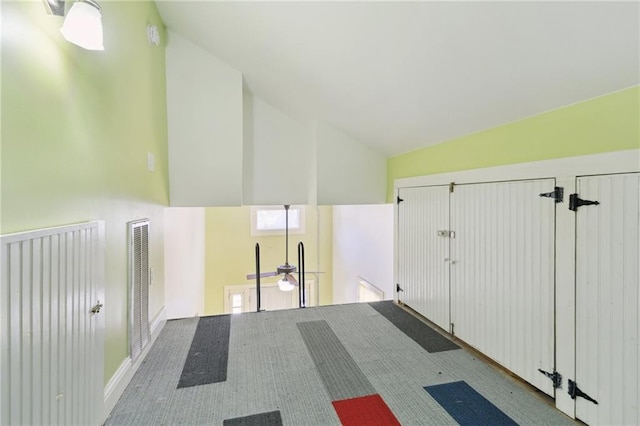 bonus room with carpet flooring and lofted ceiling