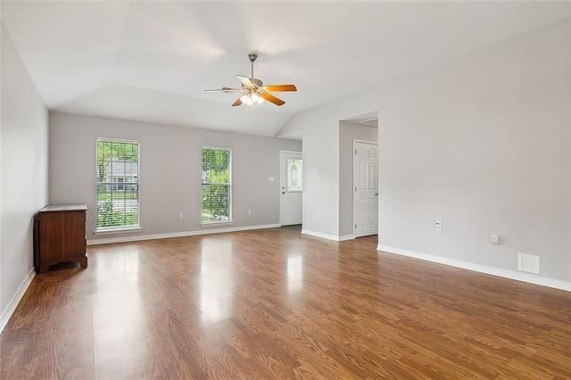 unfurnished room featuring hardwood / wood-style flooring, ceiling fan, and lofted ceiling