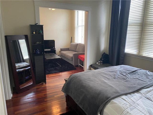 bedroom with dark hardwood / wood-style flooring