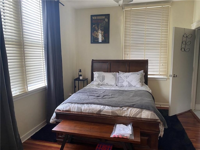 bedroom with dark wood-type flooring