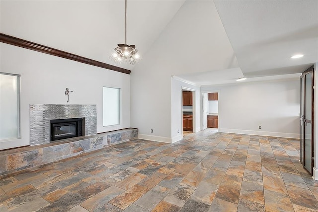 unfurnished living room with high vaulted ceiling and a chandelier