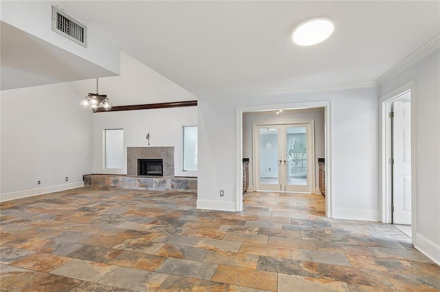 unfurnished living room with french doors, ornamental molding, and a tiled fireplace