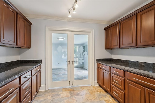 kitchen with ornamental molding, french doors, and dark stone countertops