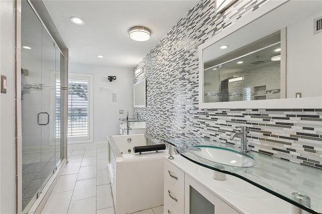 bathroom featuring vanity, tasteful backsplash, tile patterned flooring, and plus walk in shower