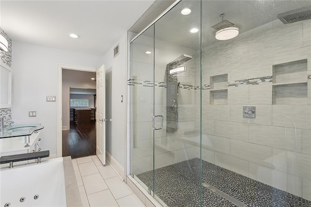 bathroom with separate shower and tub, sink, and wood-type flooring