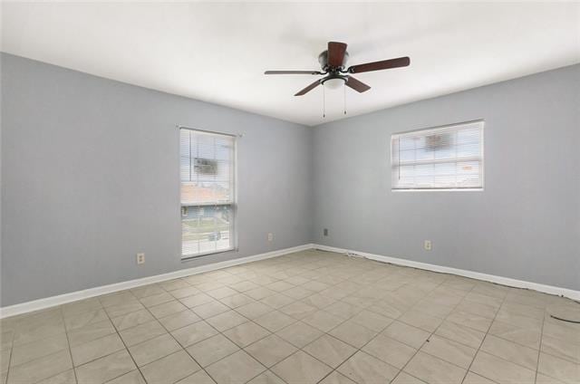 tiled empty room with ceiling fan