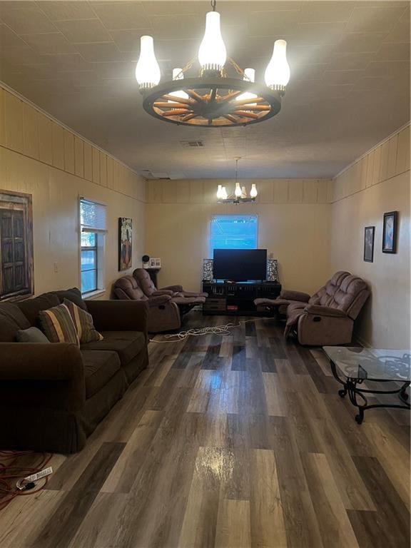 living room featuring dark wood-type flooring and a chandelier