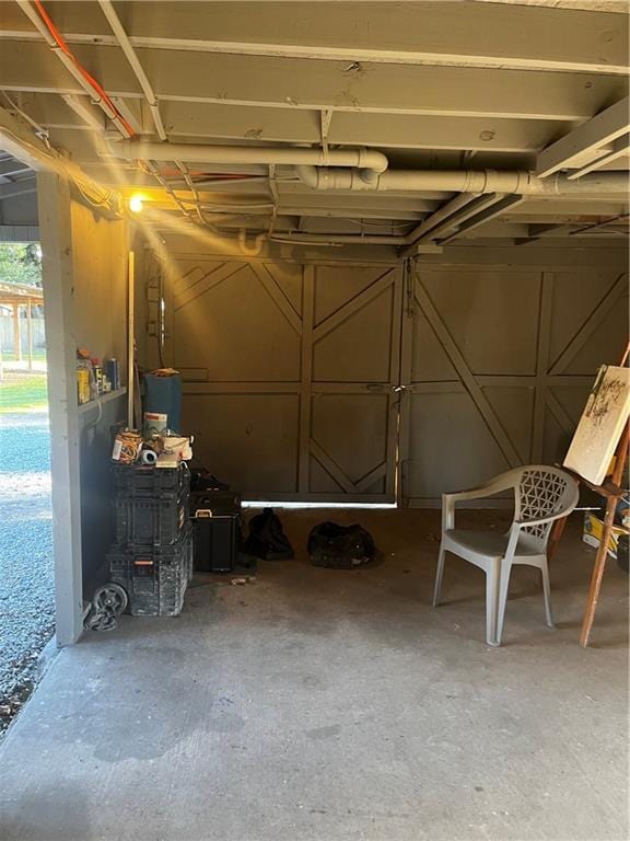 washroom featuring wood walls, a wall mounted AC, a workshop area, washer and clothes dryer, and dark hardwood / wood-style floors