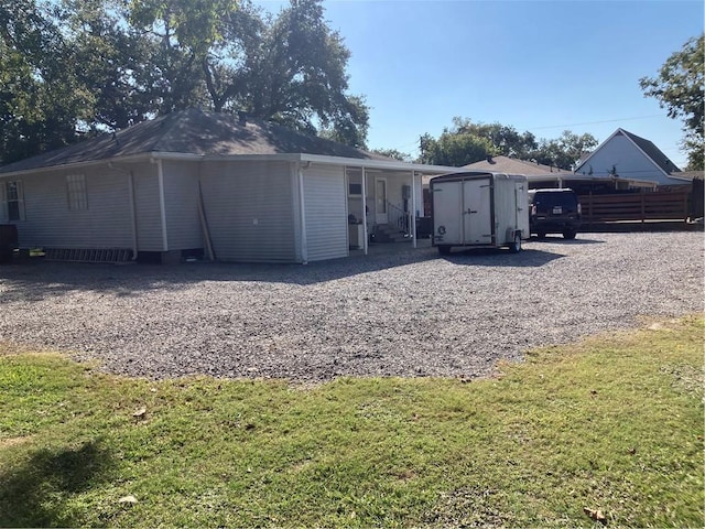 back of property with a shed