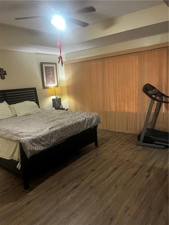 bedroom with ceiling fan and dark hardwood / wood-style flooring