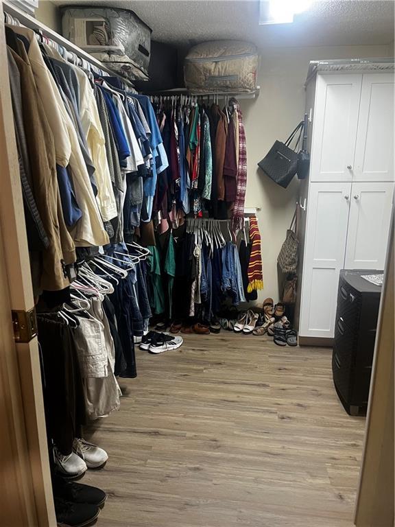 walk in closet featuring light hardwood / wood-style flooring