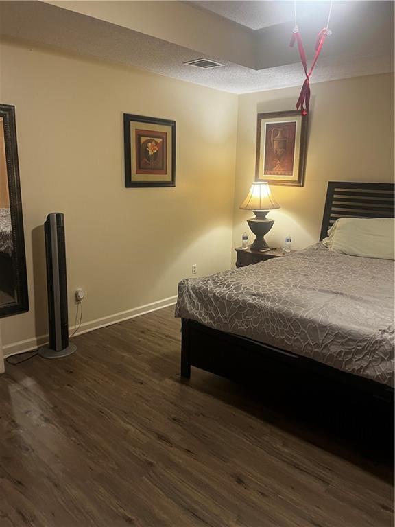 bedroom featuring dark wood-type flooring