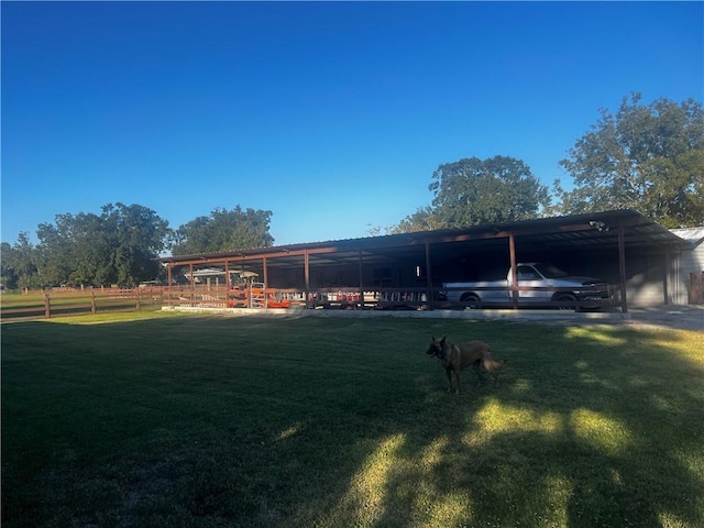 rear view of property with a carport and a rural view